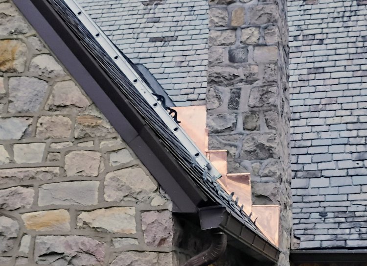 Slate cricket replaced with copper for stone chimney