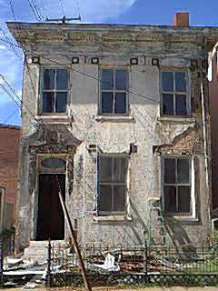 Old stucco house scored to look like block