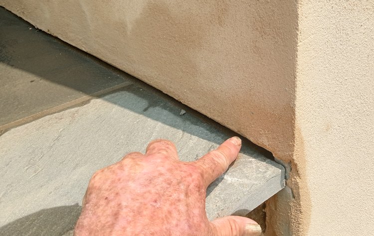 Bottom of stucco over patio showing drainage gap.