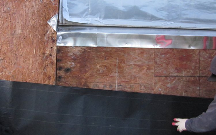 aluminum flashing and tucked it up under the window.