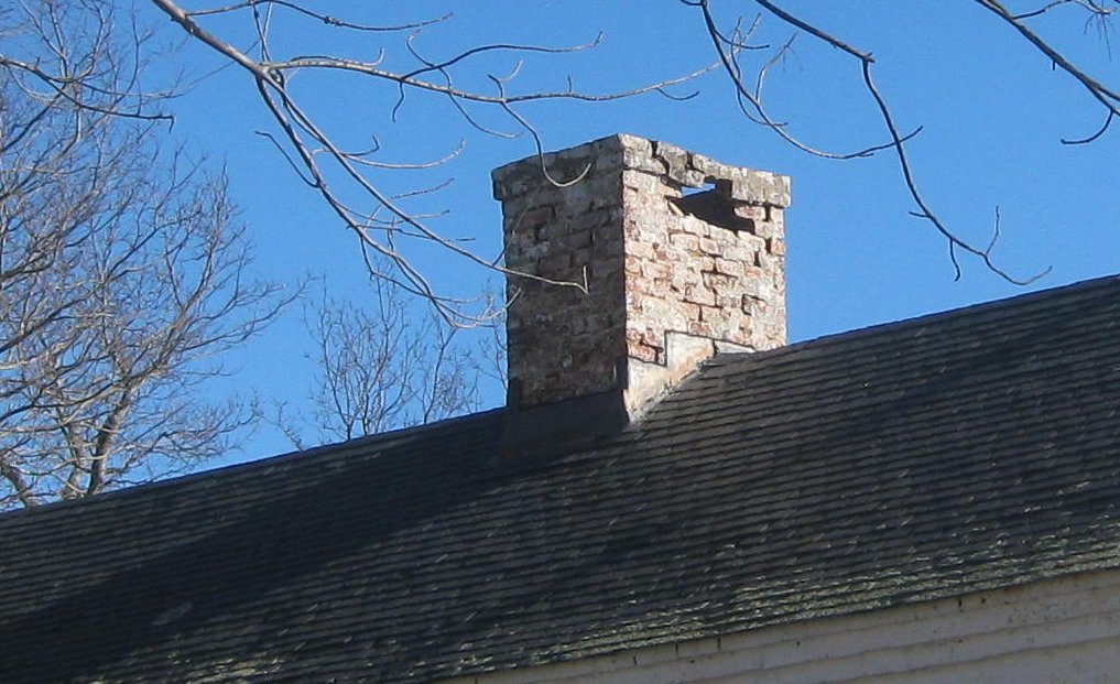 Stucco on a badly deteriorated brick chimney