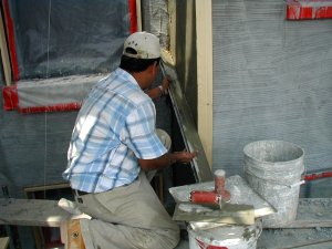 Wall is filled and rodded off between the screeds.