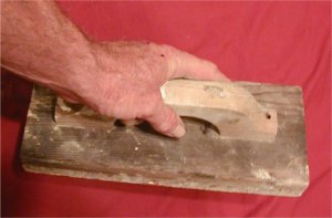 Badly out of square wall is trued up using screeds.